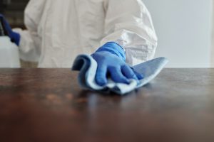 Cleaning a surface in protective clothing